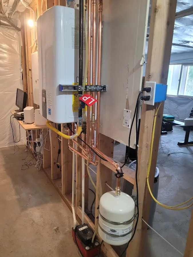 Licensed plumber repairing a kitchen sink in Mendon